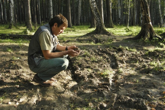 Image: Andrei Sidikov squats gravesite of last Russian czar Nicholas II's son