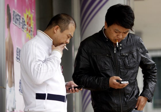 Image: People smoke in Shanghai, China