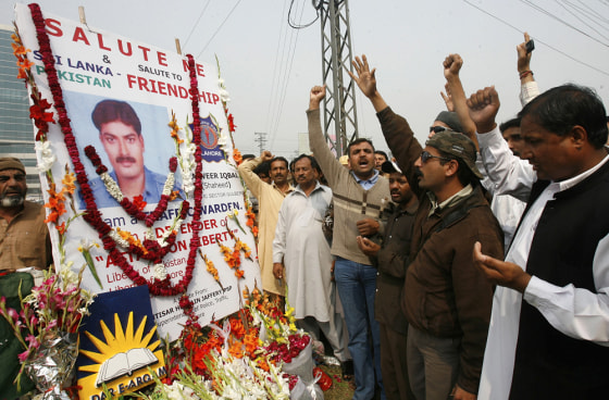 Image: Pakistani people shout slogans as they pray for victims at the site of a shooting in Lahore