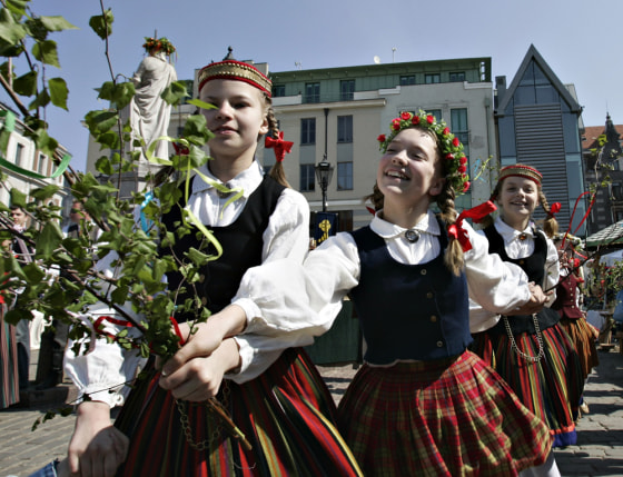 Young Latvian dancers perform a traditional dance marking the arrival of summer in 2006 in old Riga, Latvia.