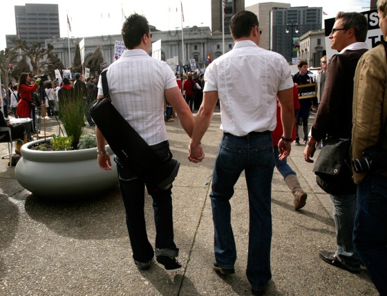Two men walk hand in hand outside California Supreme Court during Proposition 8 demonstration in San Francisco