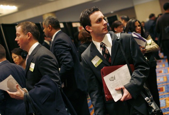 Image: People crowd a job fair