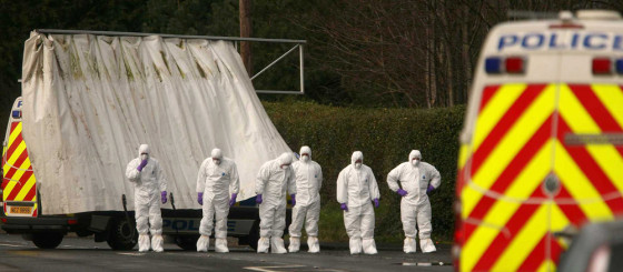 Image: Police forensic experts search the scene outside Massereene army base after two British soldiers were shot dead and four other people wounded in Northern Ireland