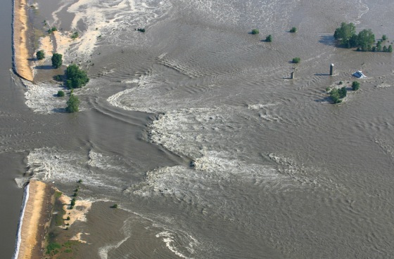 Image: The Mississippi River rushes through a break in Indian Grave Drainage District levee north of Quincy, Ill.