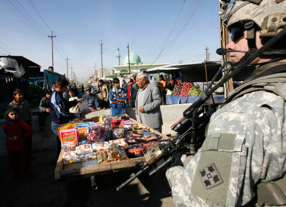 Image: A US soldier stands guard during a patrol in Mosul.