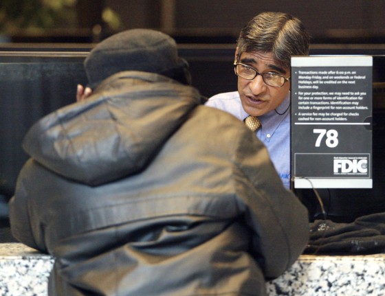 Image: Bank teller helping customer