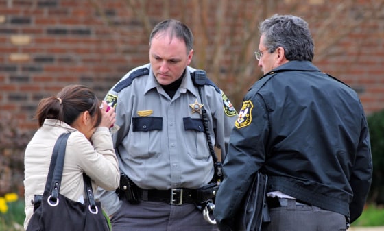 Image: Woman talking with police officers