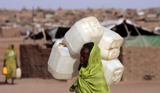 Image: A displaced Sudanese woman carries a jerrycan in search of water