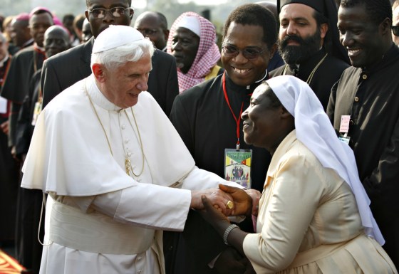 Image: Pope Benedict XVI is greeted by a Cameroonian nun