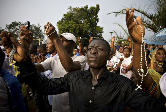 Image: Faithful rejoice as Pope Benedict arrived at the basilica to celebrate Vespers in Yaounde
