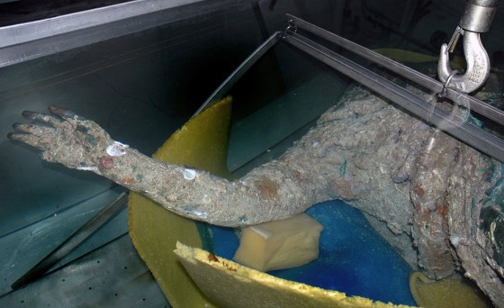 Image: The torso and raised right arm of a 2,200-year-old statue are seen after it was raised in a fisherman's nets.