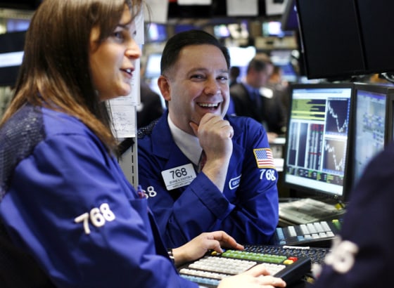 Image: A trader smiles on the floor of the New York Stock Exchange