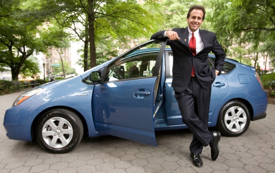 Image: Man stands near Toytoa Prius