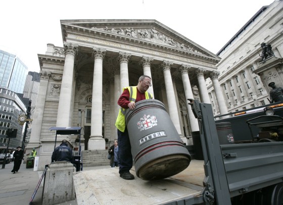 Image: A worker removes a litter bin