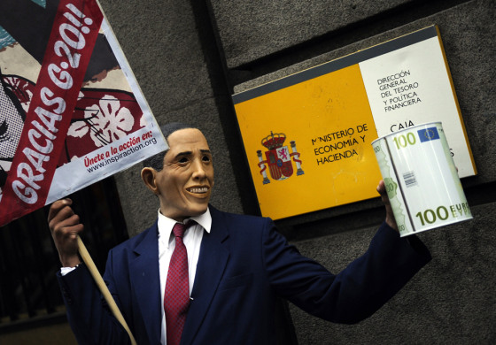 A man wearing a mask resembling President Barack Obama holds a placard reading "Crisis? Calm down, there is nothing wrong," in front of the Finance Ministry in Madrid on March 28, as part of a demonstration ahead of the G-20 summit.