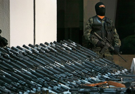 A soldier stands guard in Mexico City over a huge cache of weapons seized by Mexican authorities in November. Officials say firearms from the U.S. account for most of Mexico's drug-related killings.