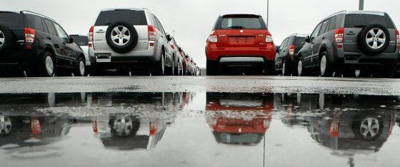 Image: Unsold Suzuki automobiles sit parked in the Dundalk Marine Terminal