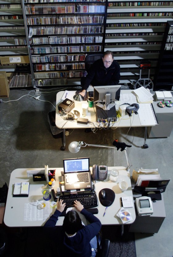 Employees catalog music CDs at Muzak’s offices.
