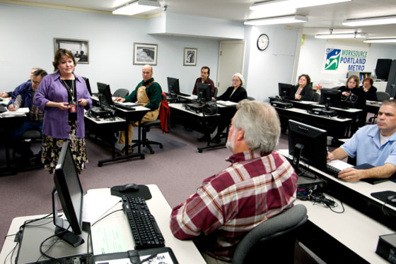 Sheila McQueen, a workforce development specialist, talks with jobseekers at a job club at WorkSource Portland Metro East on March 31 in Portland, Ore.