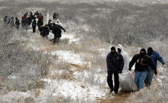Image: Police and forensic workers carry two bodies of people killed after a drug gang kidnapped and killed six people in Villa Ahumada