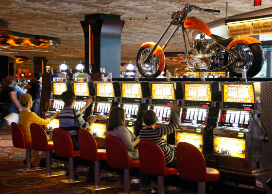 Image: People play slot machines at the Mirage Hotel & Casino