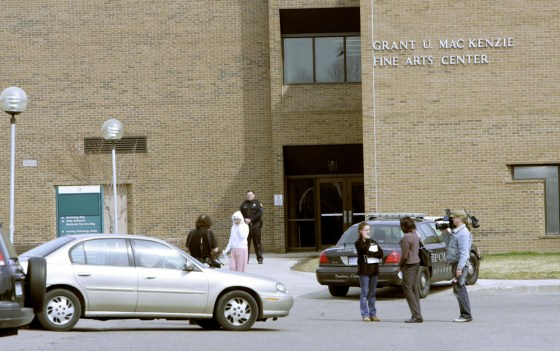 Image: police officer stands outside the Grant MacKenzie Fine Arts Center