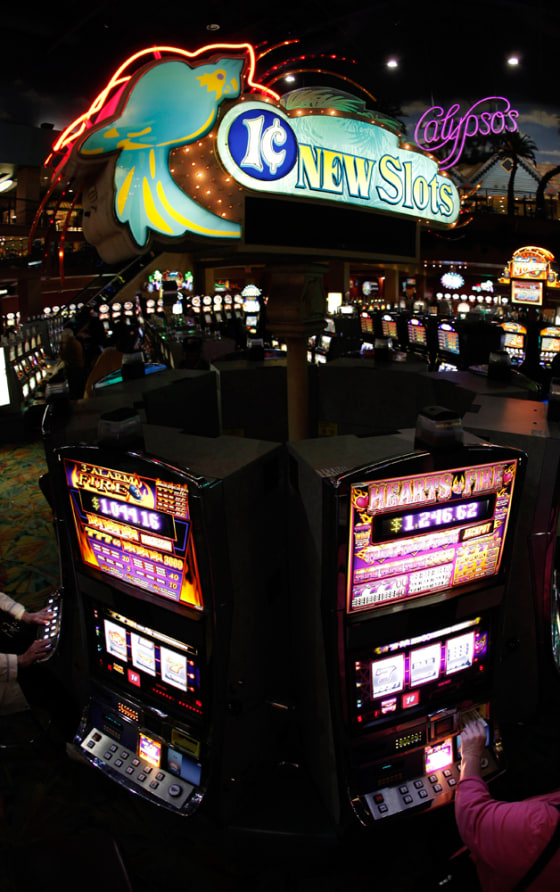 Patrons play a penny slot machine at the Isle Of Capri casino in Kansas City, Mo., on March 18.