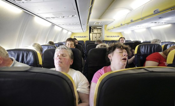 Image: Passengers sleep on a low cost flight