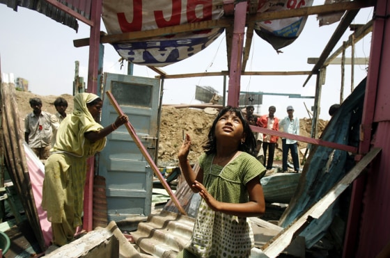 Image: Rubina Ali looks around as her house gets demolished by local authorities in Mumbai
