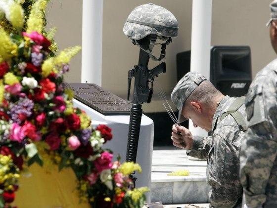 Image: A U.S. soldier holds the dog tag of 1st Lt. Roslyn Schulte