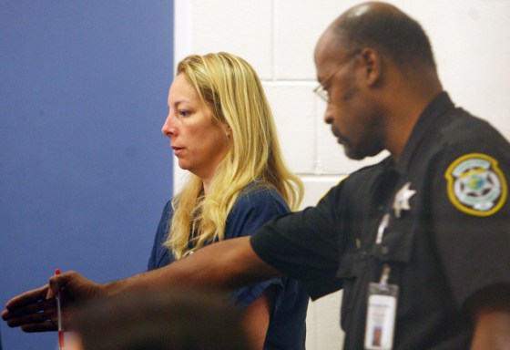 Bonnie Sweeten, left, claimed she and her daughter had been kidnapped by two black men but instead turned up at Walt Disney World. She is shown here at the Orange County, Fla. jail.