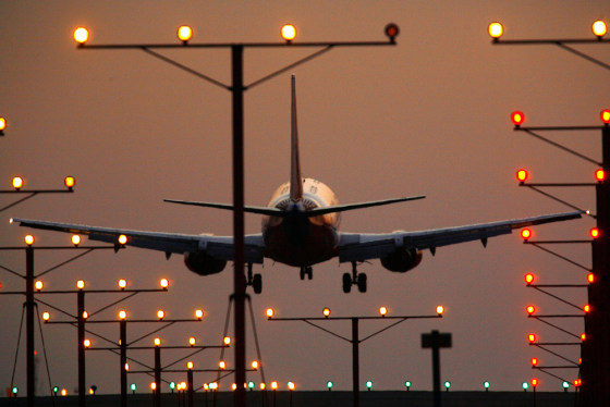 Image: A commercial jet lands at Los Angeles International Airport