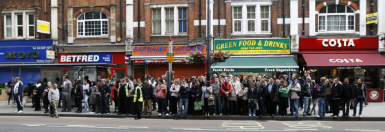 Image: Commuters queue for buses in Shepherds Bush in west London