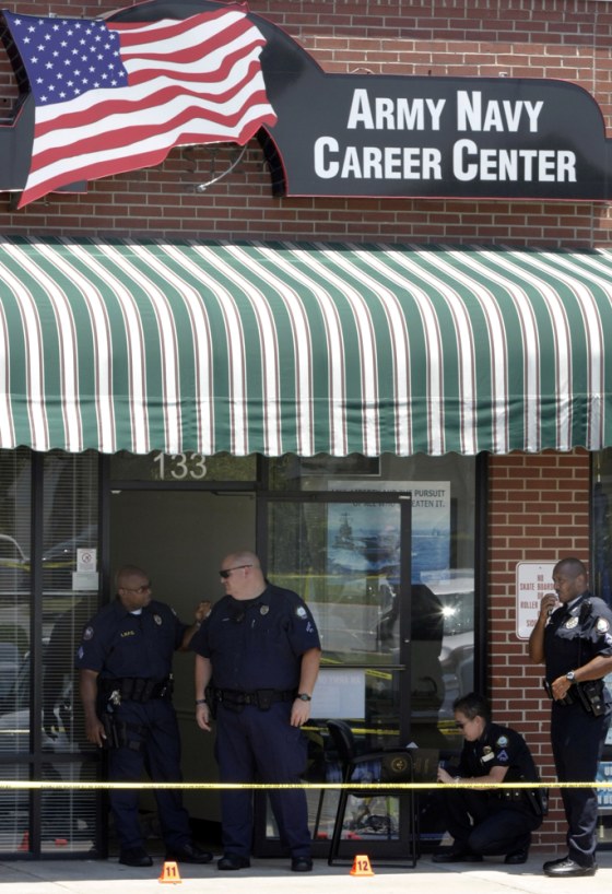 Image: police inspect the scene of a shooting outside a military recruitment office in Arkansas
