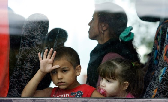 Image: Romanians leave the Ozone Leisure Centre to spend the night in sheltered accommodation, Belfast