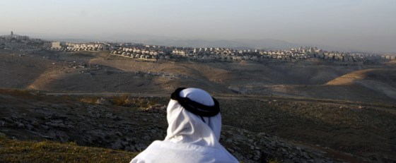 Image: A Palestinian man looks towards the Jewish settlement of Maale Adumim