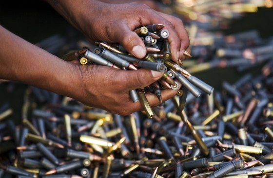 Image: A soldier picks up seized bullets