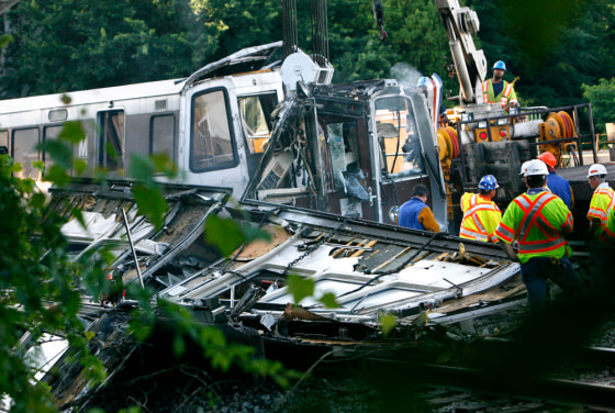 Image: Officials continue to work around the scene of a rush-hour collision between two Metro transit trains