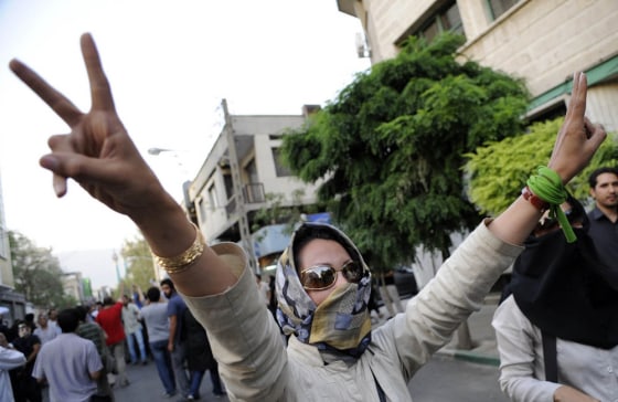 Image: A supporter of pro-reform leader Mir Hossein Mousavi, flashes victory signs during a gathering near Ghoba Mosque in Tehran, Iran