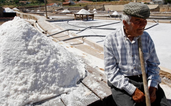 Image: A worker takes a break at the dry salt pits in Salinas