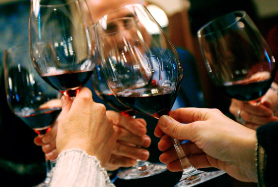 People raise their glasses in a toast at a luncheon in New York