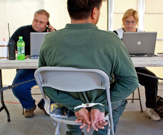 Image: Jacksonville Sheriff's Officers process a contractor