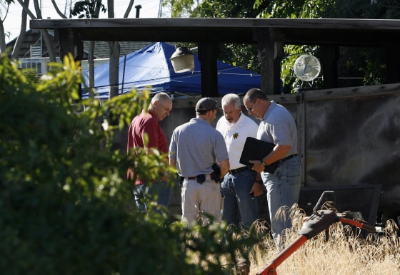 Image: Antioch police officers and Contra Costa Sheriff officers search the property next door to Phillip and Nancy Garrido's home