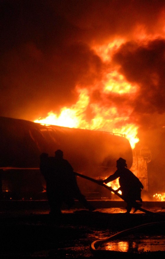 Image: Pakistani firefighters battle with a fire, after an explosion, in Chaman, a Pakistani town along the Afghan border