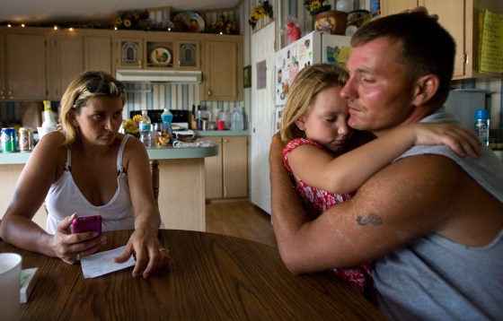 Image: James Phillips hugs his daughter after being stranded at sea