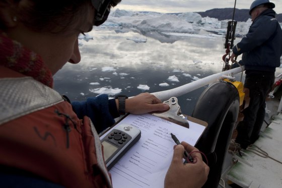 Researchers Fiamma Straneo and Jim Ryder from the Woods Hole Oceanographic Institutition deploy temperature gauges in Greenland's Sermilik fjord.