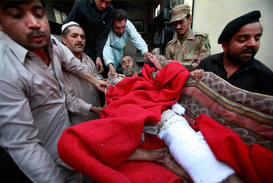 Image: Public safety workers help an injured man