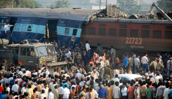 Image: Onlookers stand at site of train accident on the outskirts of Mathura