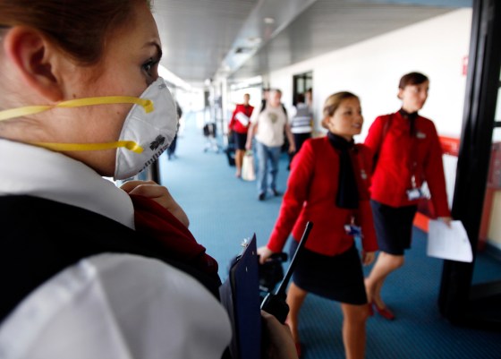 Image: An airline worker wearing a protective mask
