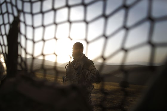 Image: A German ISAF soldier gets ready to join a patrol in Yaftal e Sofla